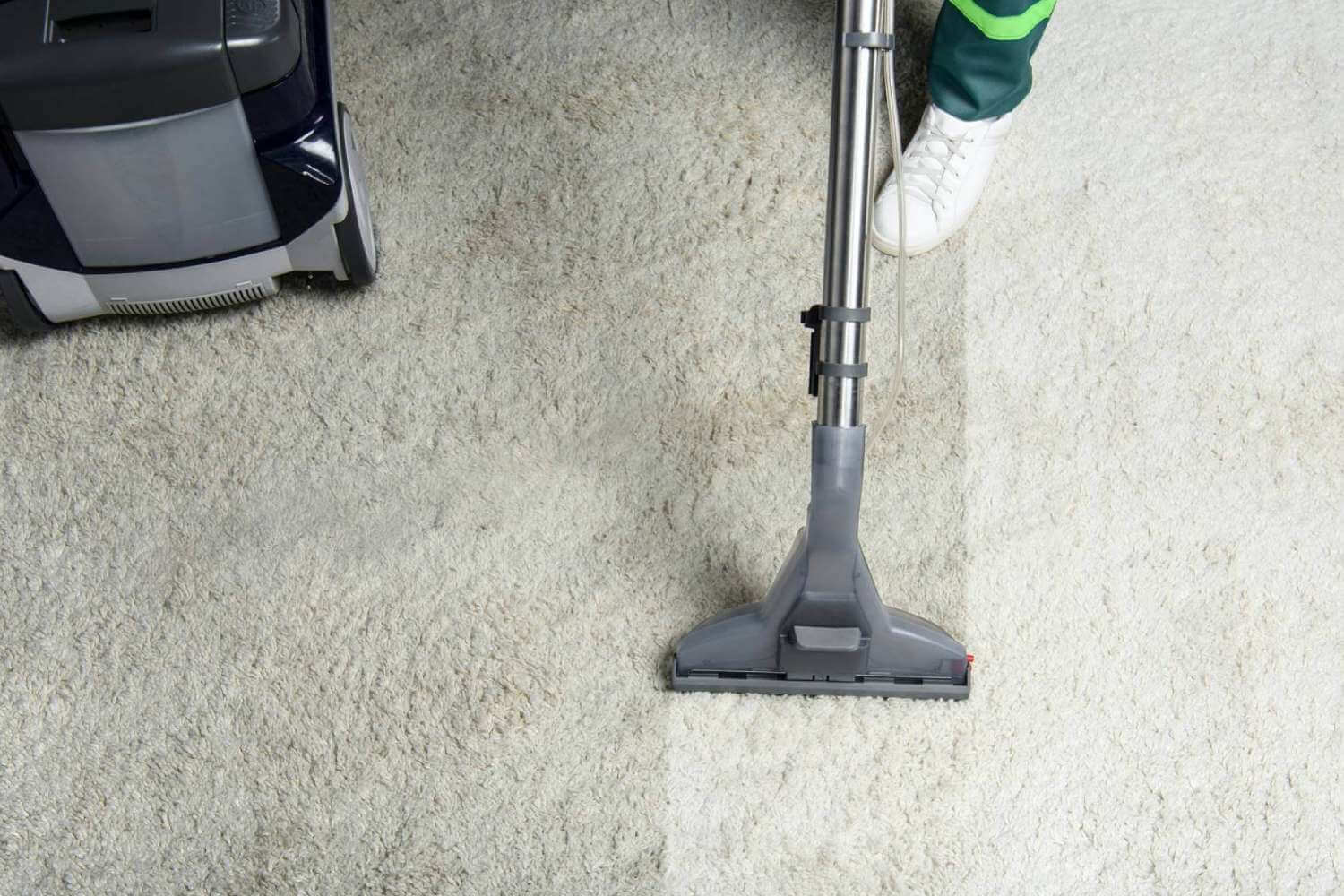Mighty Clean professional cleaning carpet in white shoes